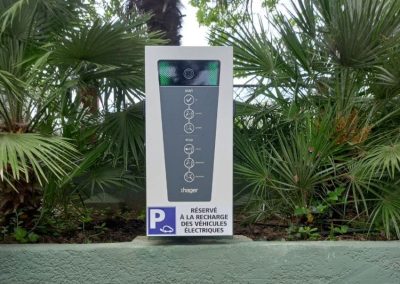 Photo d'une borne de recharge électrique sur un muret